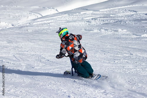 Riding downhill on a snow bike (skiing) photo