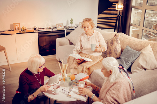 Good looking senior women sharing love to literature photo