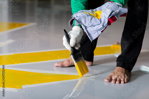 Construction series: Worker painting parking lot stripe
