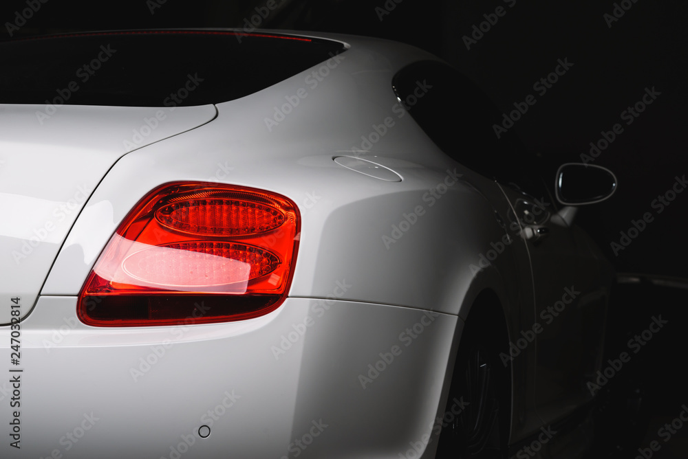 Car detailing series: Clean taillight of white luxury car