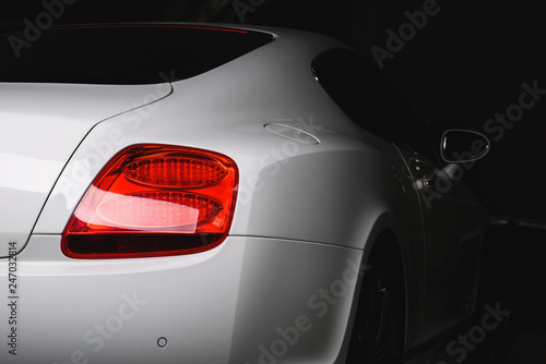 Car detailing series: Clean taillight of white luxury car