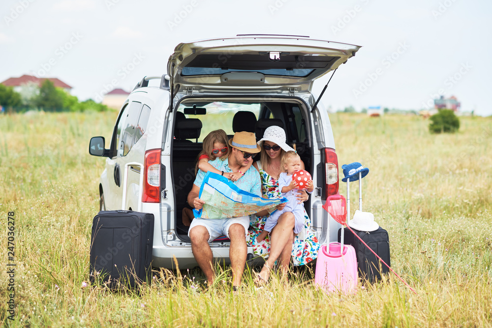 Vacation, Travel - family ready for the travel for summer vacation. suitcases and car route. People with map in hands planning road trip. travel concept. traveler. Vacation, Travel - family ready for the travel for summer vacation. suitcases and car route. People with map in hands planning road trip. travel concept. traveler.