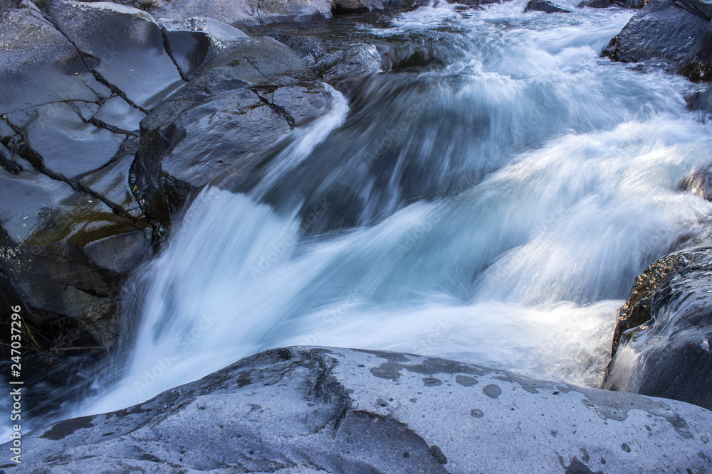 Waterfall in Sicily, volcanic stone in the river Waterfall in Sicily, volcanic stone in the river