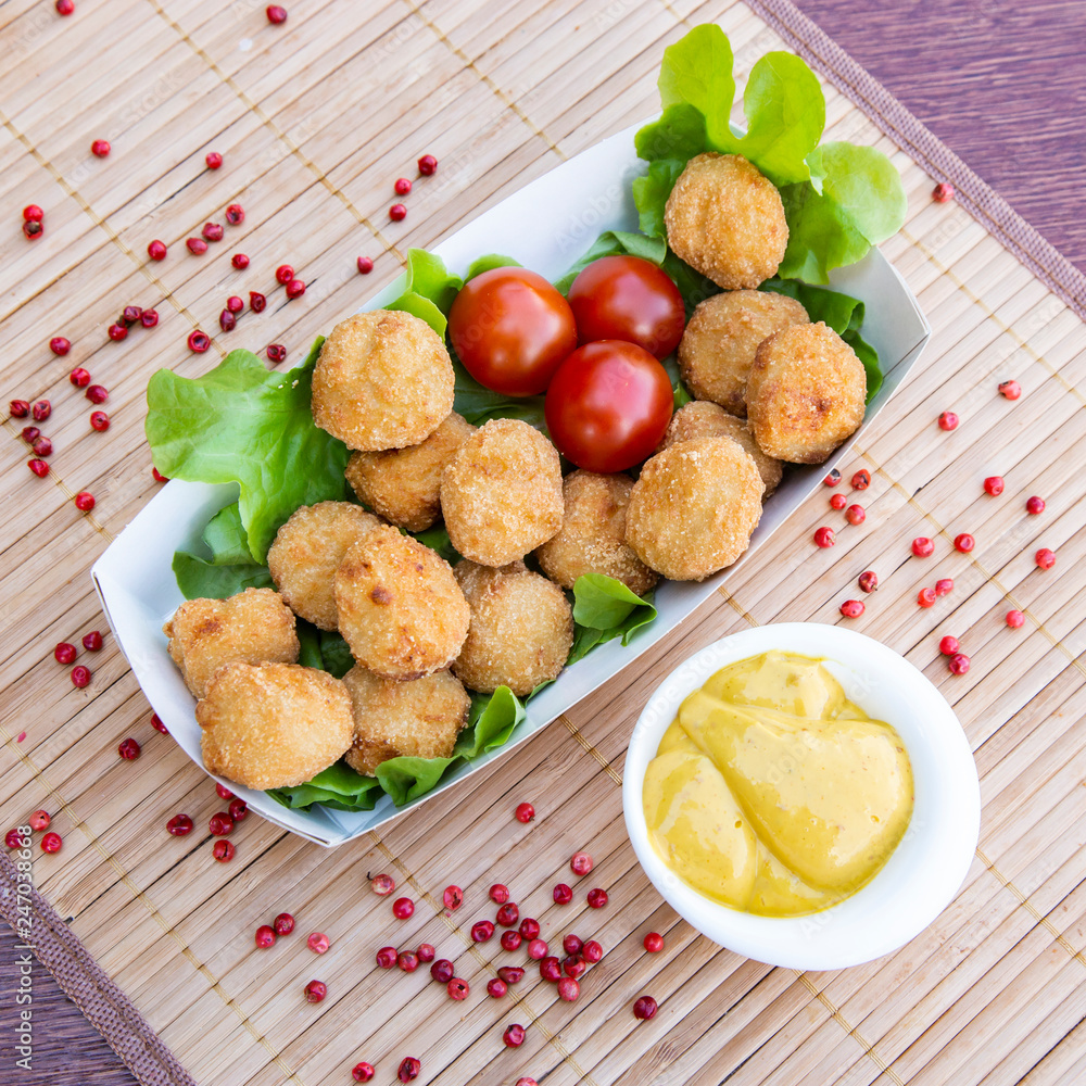 Chicken meatballs with lettuce, tomato and mustard sauce Chicken meatballs with lettuce, tomato and mustard sauce