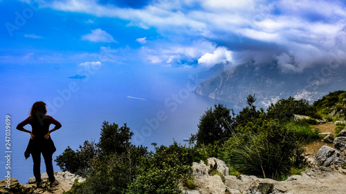 A woman from the back watching the magnificent view at God s Path trail above Amalfi coastline  Italy.
