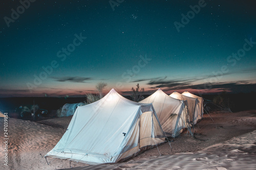 Amazing adventure trip in the Sahara desert, tent camp among the dunes under starry sky