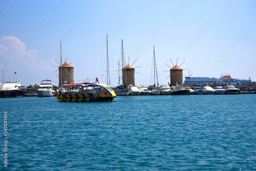 The windmills,fort of St Nikolas,Church of the Assumption and the Governors palace are on Rhodes Mandraki Harbour The windmills,fort of St Nikolas,Church of the Assumption and the Governors palace are on Rhodes Mandraki Harbour