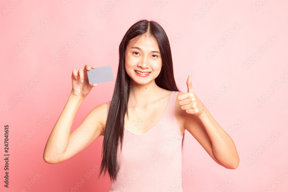 Young Asian woman thumbs up with a blank card. Young Asian woman thumbs up with a blank card.