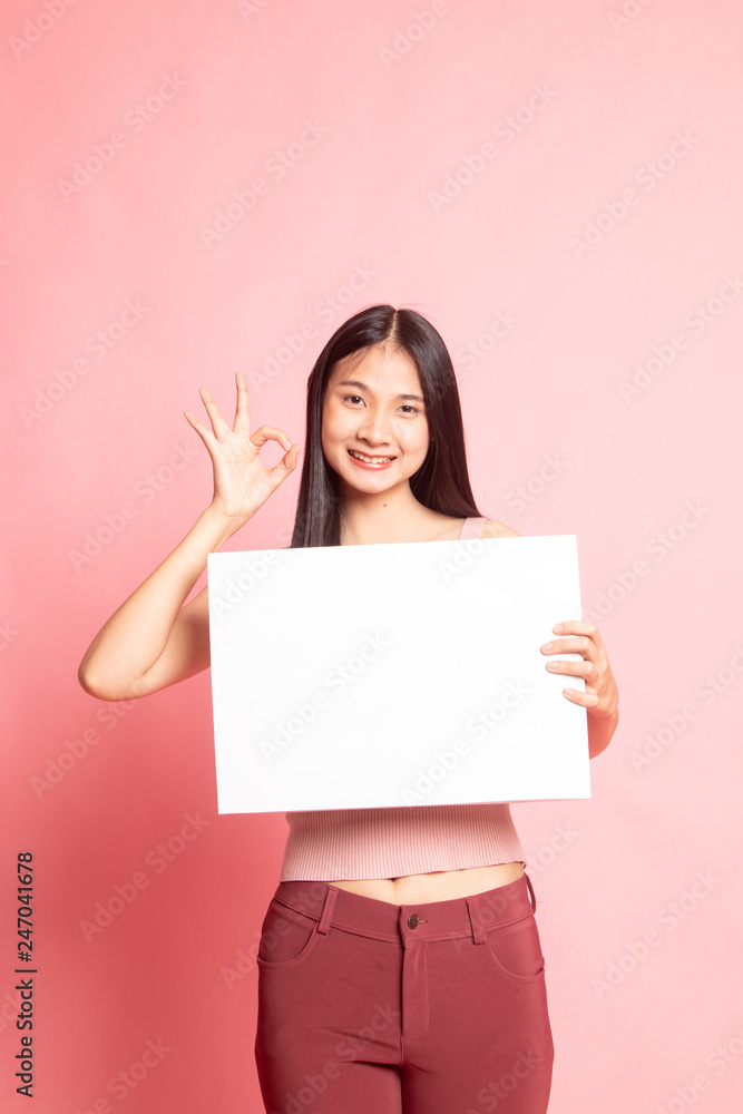 Young Asian woman show OK with white blank sign. Young Asian woman show OK with white blank sign.