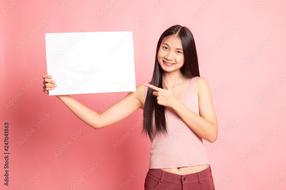 Young Asian woman point to  blank sign.