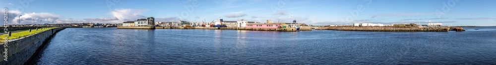 Panorama with Galway harbour, Corrib river and Galway buildings with reflection