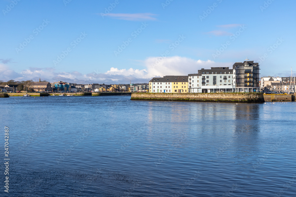 Corrib river and Galway buildings with reflection