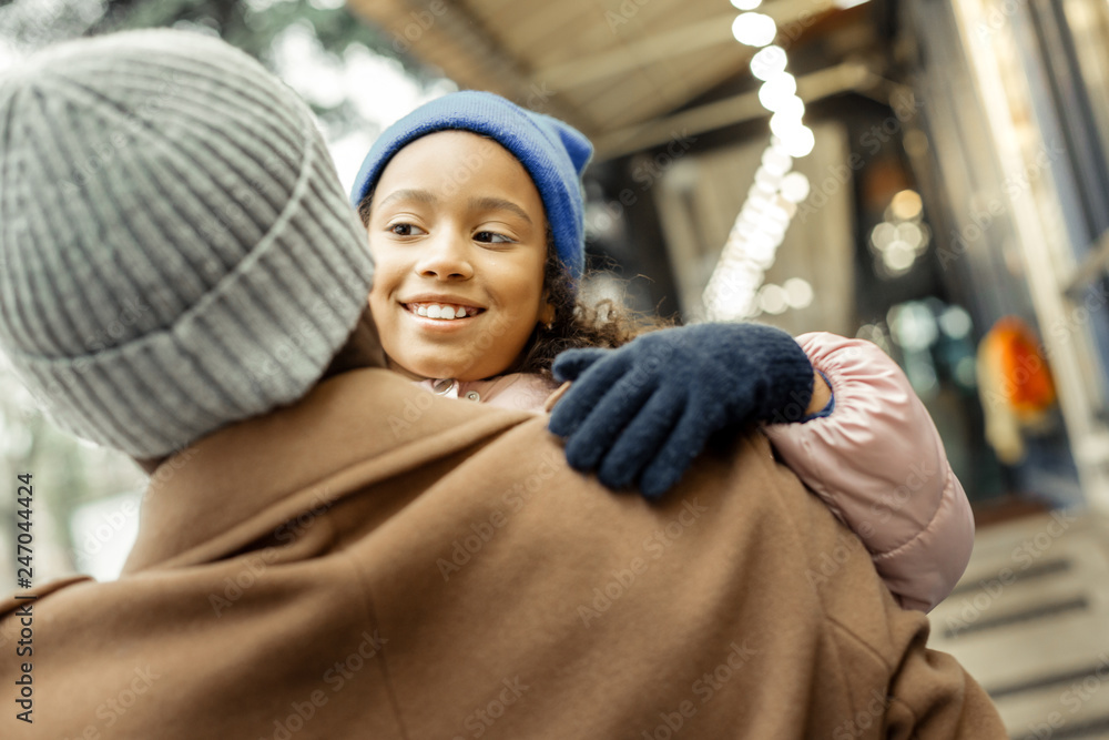 Obraz premium Beautiful curly daughter feeling cheerful spending time with father