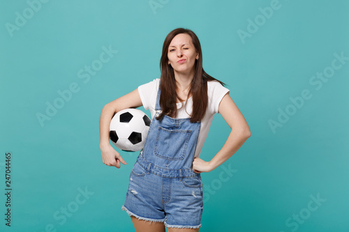 Pretty blinking young woman football fan cheer up support favorite team with soccer ball isolated on blue turquoise wall background. People emotions, sport family leisure concept. Mock up copy space. © ViDi Studio