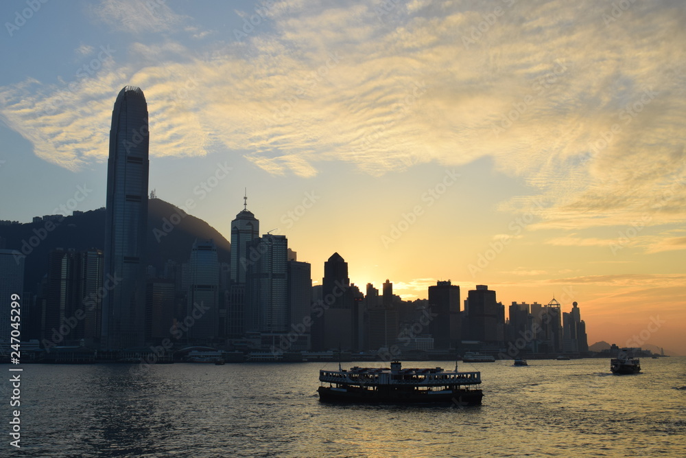 Fototapeta premium Starr Ferry crossing the Victoria Harbor in Hong Kong during Sunset