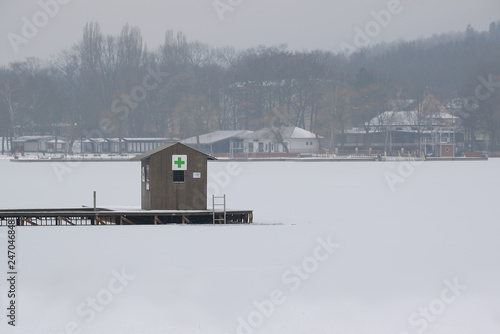 First aid station on Kamencove jezero lake near czech city of Chomutov in winter photo