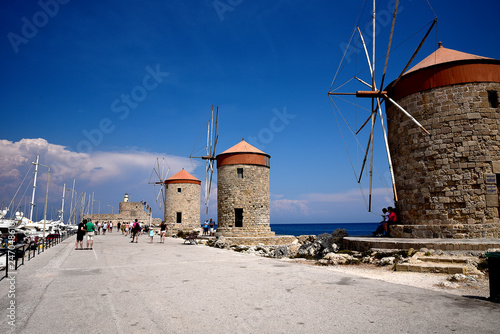 The windmills,fort of St Nikolas,Church of the Assumption and the Governors palace are on Rhodes Mandraki Harbour 