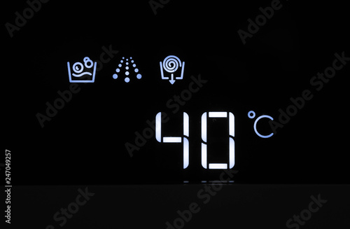 Washing machine panel display, setting 40 degrees temperature. Abstract laundry programming.