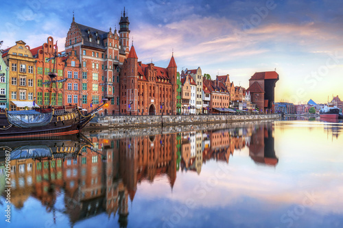 Gdansk with old town and port crane reflected in Motlawa river at sunrise  Poland.
