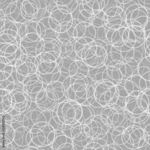 Abstract seamless pattern of randomly arranged contours of circles in white and gray colors