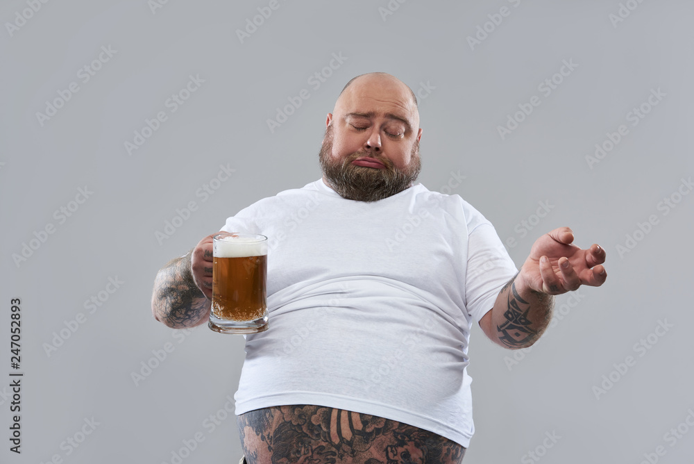 Funny fat man looking drunk while standing with beer Stock Photo | Adobe  Stock