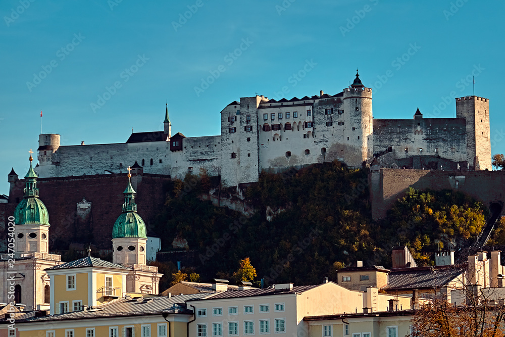 Festung Hohensalzburg Fortress in Salzburg in Austria - medieval castle at cliff under the old town. Famous landmark with summer sky