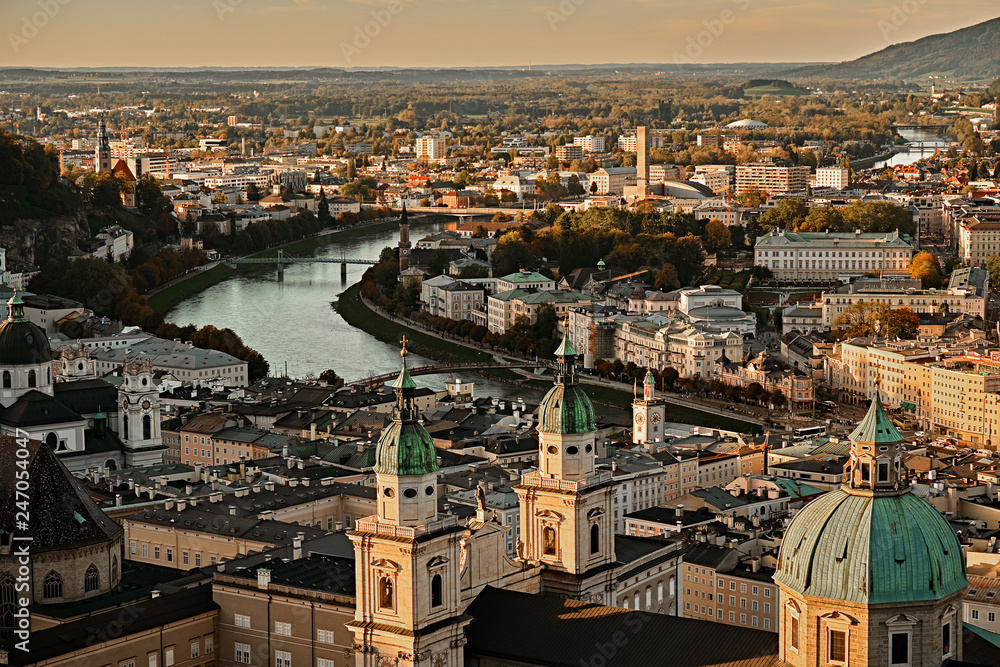 Beautiful sunset aerial view on Salzburg, Austria, Europe. City in Alps of Mozart birth. Panoramic view of Salzburg skyline from Festung Hohensalzburg in autumn. Famous town