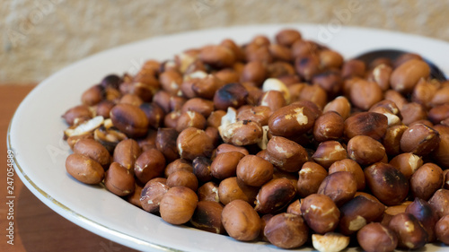 Roasted Peanuts Snack in White Plate in Wooden Backgrounds - topview ans Closeup