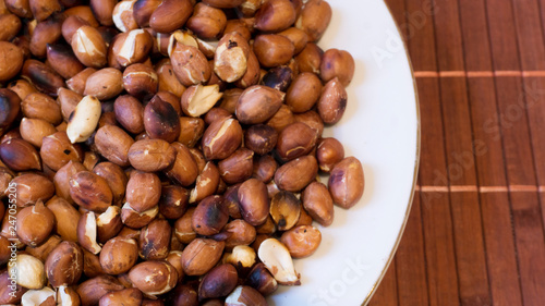 Roasted Peanuts Snack in White Plate in Wooden Backgrounds - topview ans Closeup