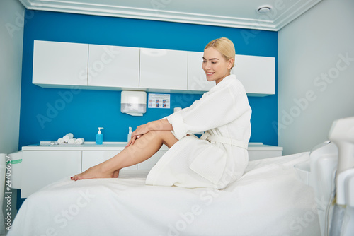 Beautiful girl resting in cosmetologist cabinet and waiting for procedure