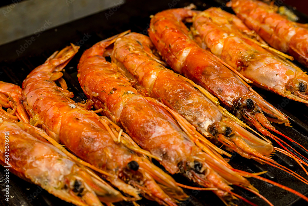 set of large red shrimps Argentinean whole sea delicacies with head group of delicacies on the grill