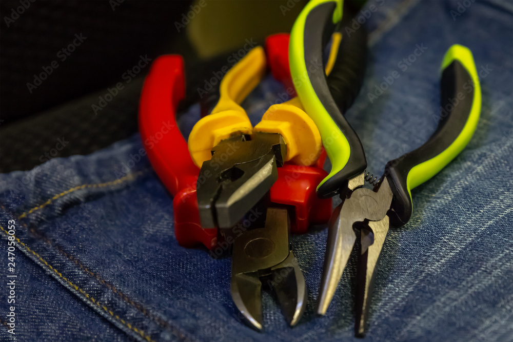 grunge style background set nippers colorful pen red green tools repair electrical equipment on jeans background grunge style background set nippers colorful pen red green tools repair electrical equipment on jeans background