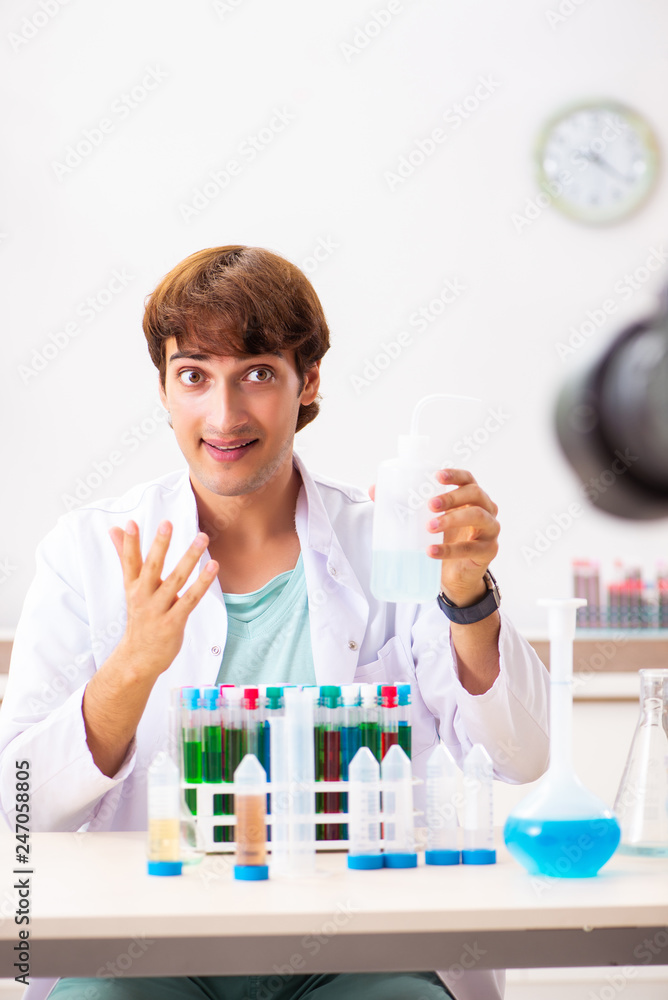 Fototapeta premium Chemist blogger recording video for his blog
