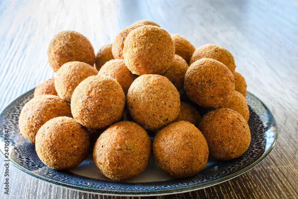 Deep fried fish balls on a bowl on wooden background Deep fried fish balls on a bowl on wooden background