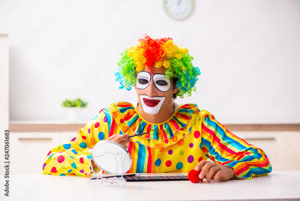 Male clown preparing for perfomance at home Male clown preparing for perfomance at home