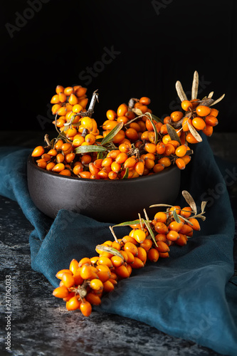 Ripe orange berry, sea buckthorn. Vitamins. Dark background