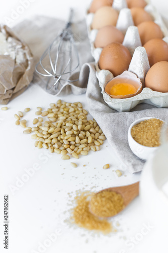 Ingredients for homemade baking. Eggs, milk, flour, sugar. White background, side view