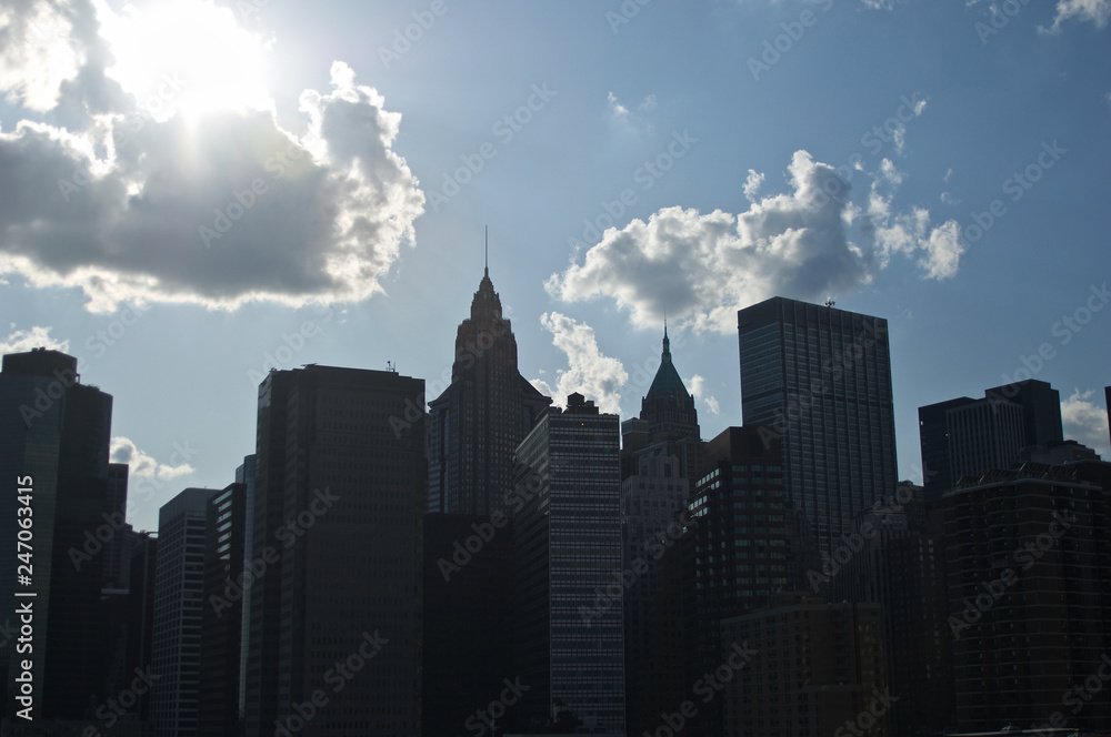 A cluster of buildings on New York City's lower Manhattan as seen from the Brooklyn Bridge.