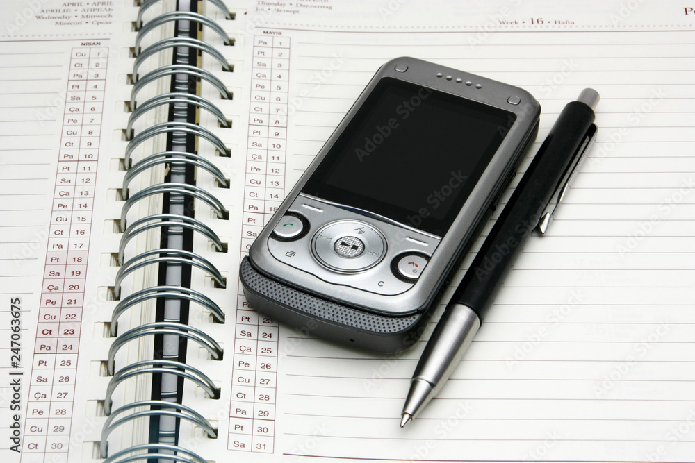 The diary phone and pen close-up. Business meeting schedule and important concept notes. Schedule. The diary phone and pen close-up. Business meeting schedule and important concept notes. Schedule.