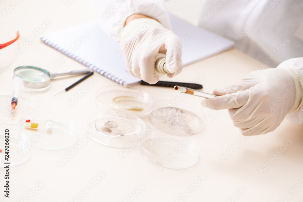 Young expert criminologist working in the lab 