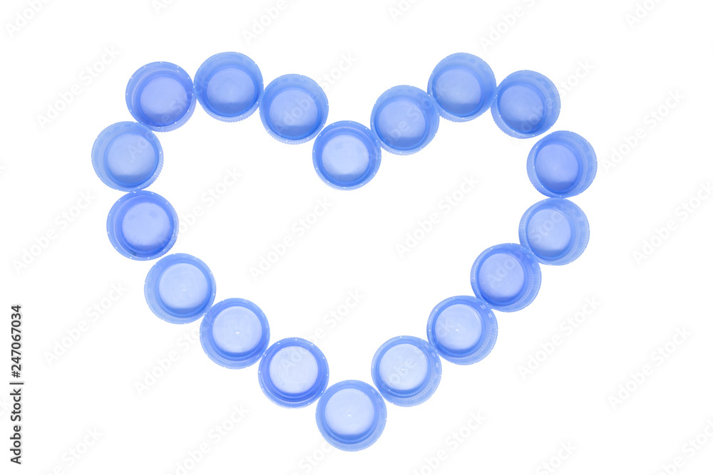 Heart made of blue plastic botlle сaps isolated on white background Heart made of blue plastic botlle сaps isolated on white background