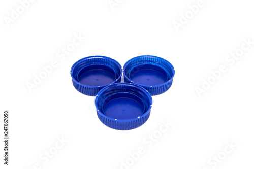 Three blue plastic caps in a shape of triangle isolated on white background. Recycling concept