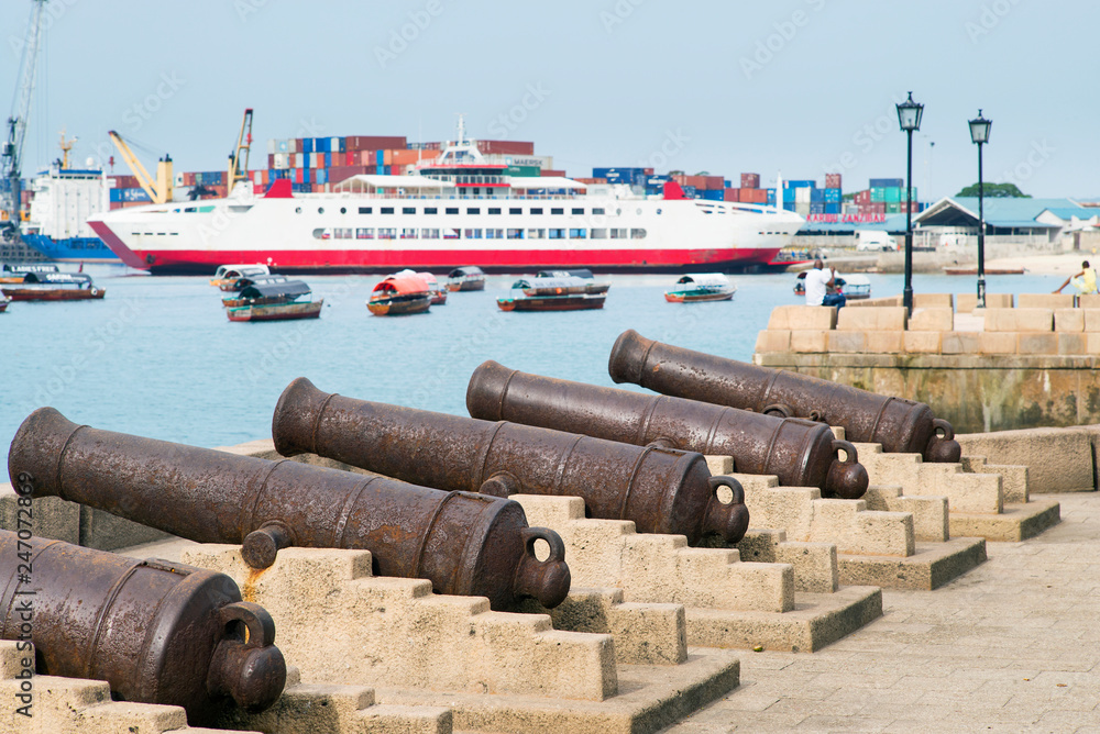 old guns on embankment in front of harbor in Zanzibar in Tanzania old guns on embankment in front of harbor in Zanzibar in Tanzania