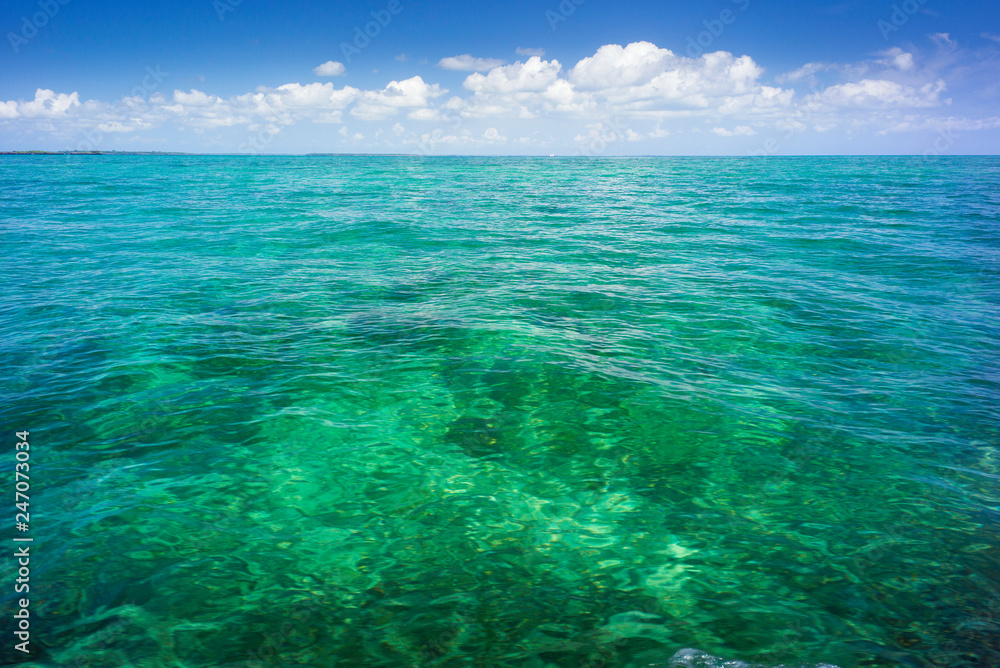 sea view to horizon and sky with clouds above emerald water on Zanzibar island in Tanzania
