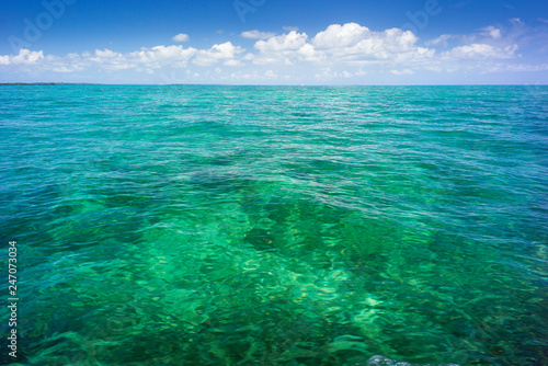 sea view to horizon and sky with clouds above emerald water on Zanzibar island in Tanzania