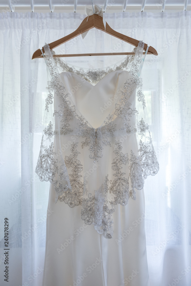 White wedding dress hanging up before the wedding White wedding dress hanging up before the wedding