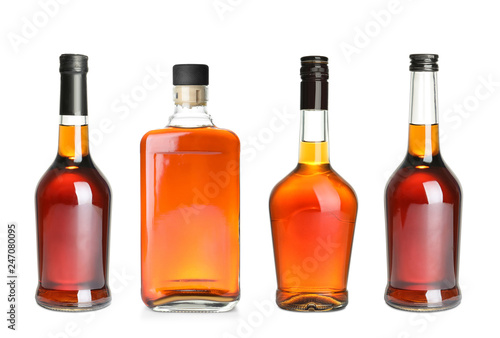 Set of bottles with expensive whiskey on white background