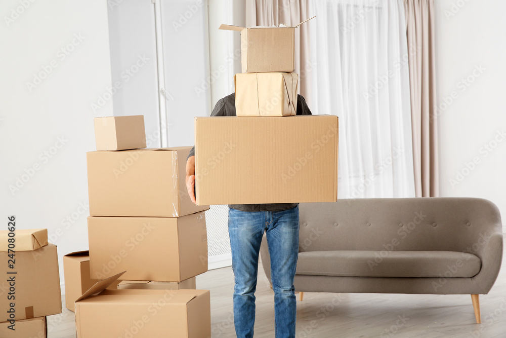 Man with moving boxes in his new house Man with moving boxes in his new house