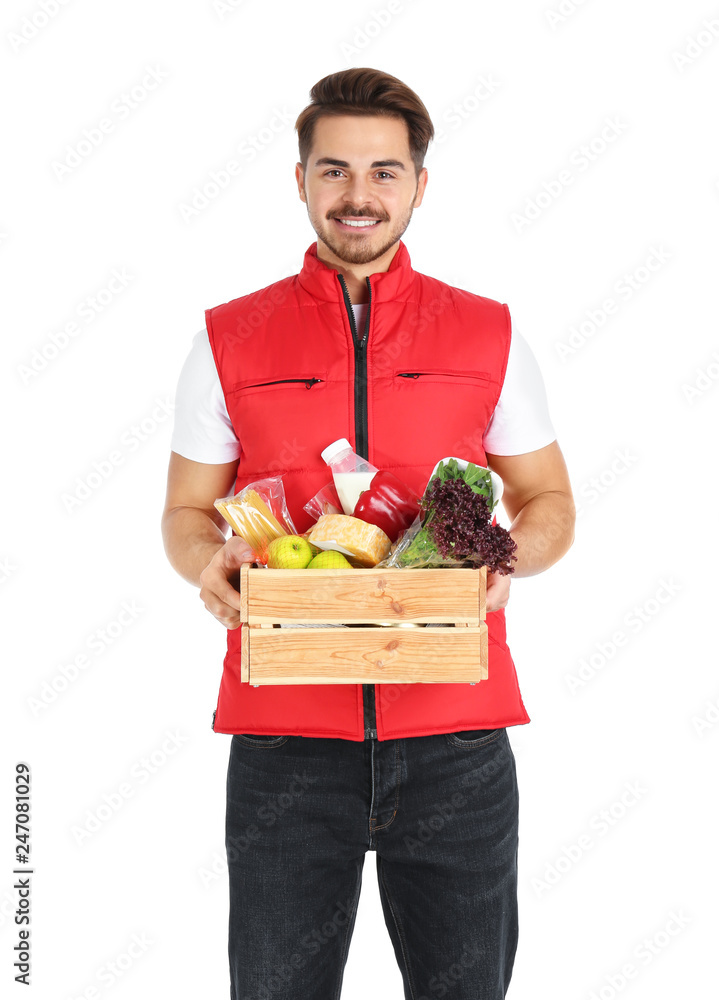 Young man holding wooden crate with products on white background. Food delivery service Young man holding wooden crate with products on white background. Food delivery service