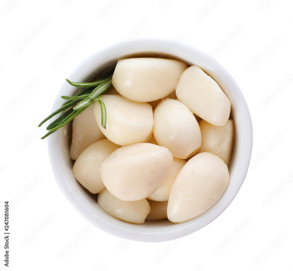 Bowl with preserved garlic and rosemary on white background, top view Bowl with preserved garlic and rosemary on white background, top view